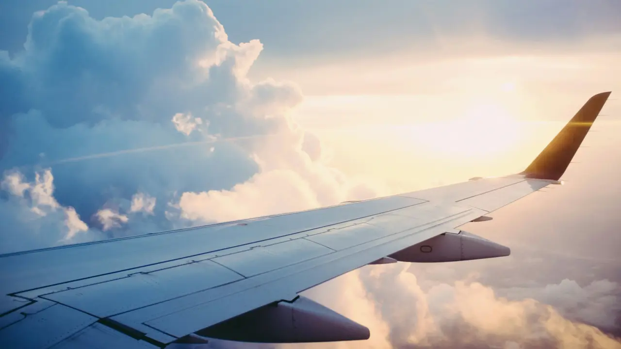 Aircraft wing above the clouds in the evening light